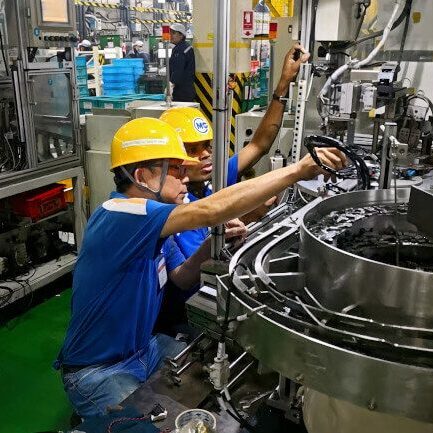 TNC engineers assembling a part feeding system